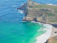 A stunning aerial shot of Cape Point's rugged coastline, showcasing vibrant blue and green hues.